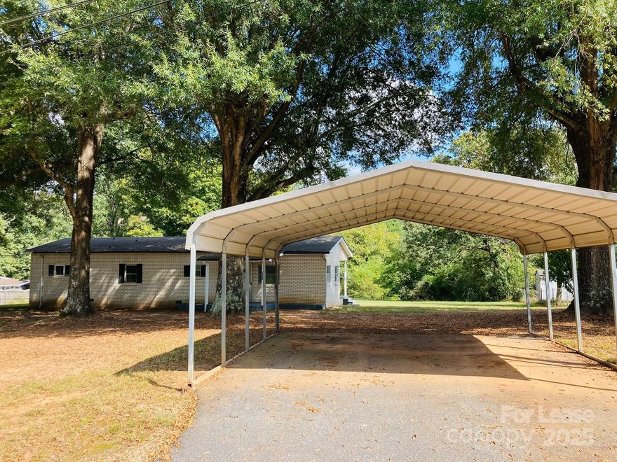 This cozy 2-bedroom, 1-bathroom double-wide in Maiden, NC is ready for immediate occupancy. The bright living room includes a ceiling with exposed beams. The kitchen comes equipped with a large island, electric range and refrigerator. The primary bedroom boasts a bump out and oversized closet. 2nd bedroom includes a built in desk area. Large secluded lot and a back deck including shed and parking cover to enjoy. Tenant is responsible for all utilities, lawn maintenance and landscaping. NO smoking or pets allowed.