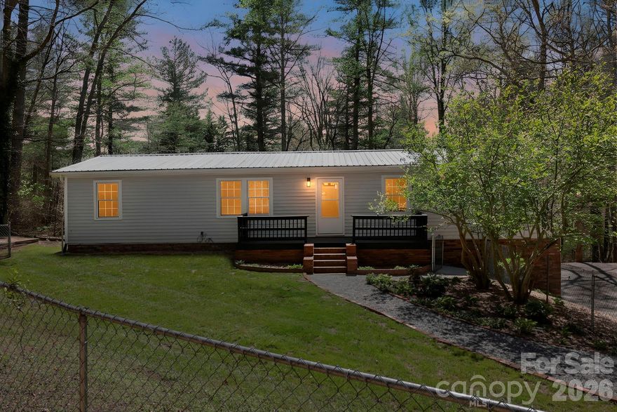 Welcome to 5 Country Road! This home is located right across from Rugby Middle School, just 8 minutes west of downtown Hendersonville. The Asheville Airport is only about 10 more minutes to the north, and you can be on I-26 in about 7 minutes—this location couldn’t be more convenient. Plus, the home sits directly off a state-maintained road, so there’s no need to worry about maintaining a private shared driveway.

The main level offers true one-level living. Downstairs, you’ll find a full bathroom, a kitchen, a living room, and two office-like rooms. While these rooms may appear similar to bedrooms, they are not classified as such.

The main level features central forced air, while the lower level is heated with an oil system. The seller also installed solar panels not too long ago, with over 30 years remaining on the warranty.

With no HOA and no known restrictions, the options here are endless. Call, text, or email today to schedule your tour of this amazing opportunity!