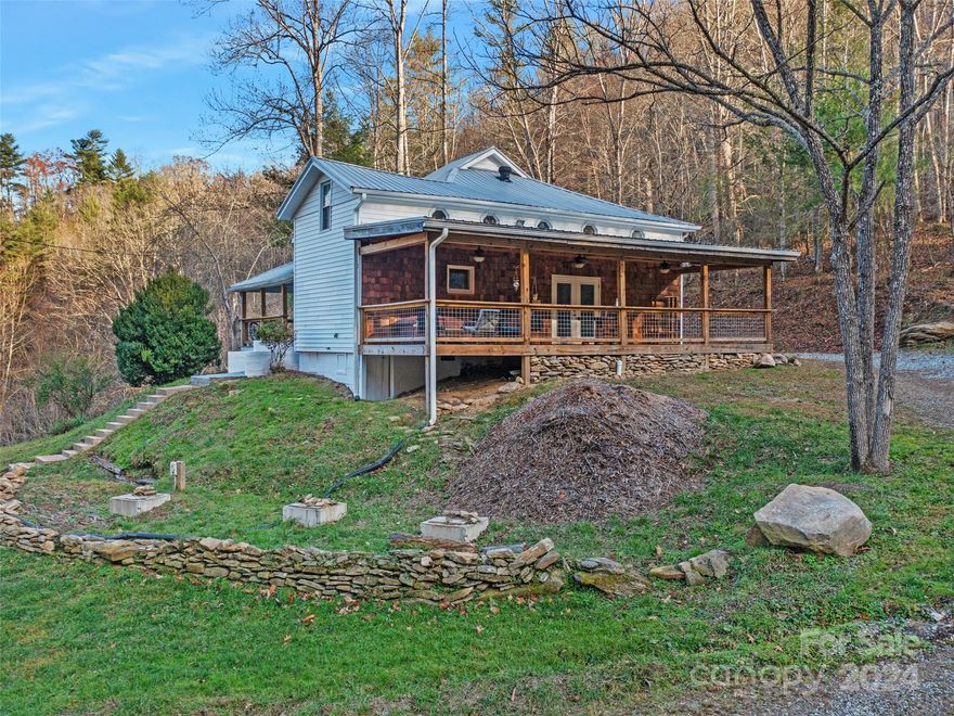 24 Hour Notice Required to show.  Listing Agent must accompany all showings.  27 Acres of Appalachian Charm: Discover a private retreat on 27 stunning acres, offering a perfect blend of seclusion and proximity. Anchored by a fully remodeled farmhouse, this property boasts modern comforts with timeless appeal: tile showers, new cabinets, and curated lighting create a warm and inviting space. With multiple build sites available, the possibilities are endless. The state-maintained Lower Paw Paw Road ensures reliable access, making it convenient while maintaining your privacy. Surrounded by open space and natural beauty, this property is ideal for those seeking peace, quiet, and a connection to the land. Whether you envision expanding your living space, enjoying the serenity of mountain life, or creating a small homestead, this property is ready to inspire the next chapter of your story. Come for the charm… stay for the land. Portion of PIN being sold. Septic system already in place for 3 more home sites.