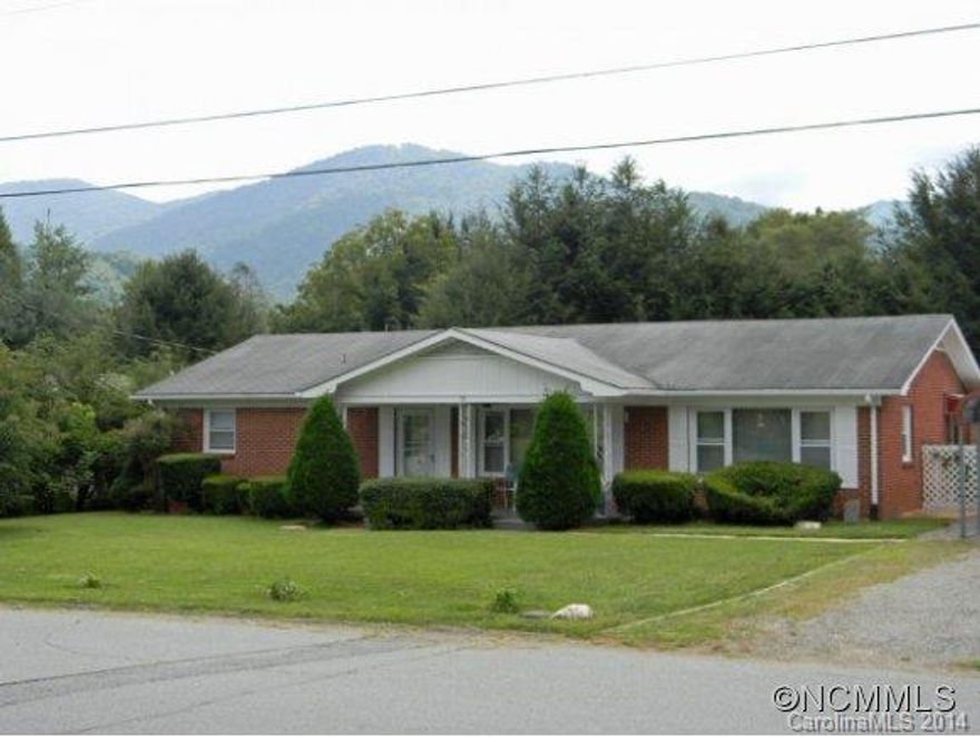 This classic brick ranch house features wonderful picture windows across the front making the interior floor plan light and bright. 4 spacious bedrooms including a roomy in-law suite with separate entrance, eat-in kitchen, den and living room overlooking the covered front porch. The patio and lovely backyard are great for cookouts, playtime and gardening. Convenient in-town Waynesville location.
