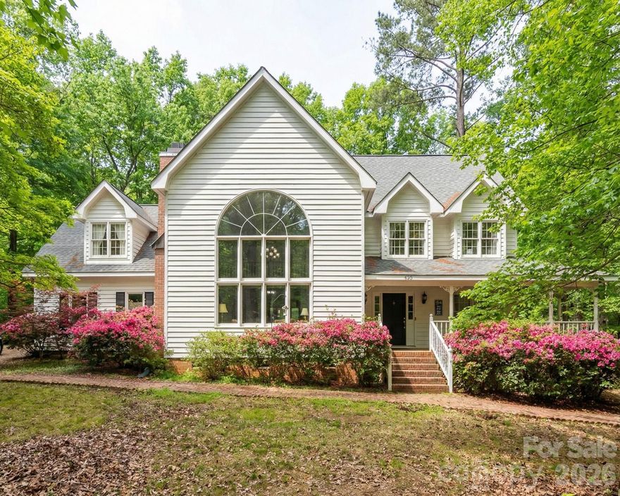 Charming owner-built modern Victorian-style home nestled on a quiet cul-de-sac just outside the city of Monroe, NC. Surrounded by mature trees, this residence offers privacy, character, and flexible living space with 4 bedrooms, a bonus room, office, and 3 full baths. The wide front porch opens to a bright, open-concept kitchen, dining, and living area with a large picture window and balcony. The main level features a private bedroom with adjoining sitting room—ideal for a mother-in-law suite, a second primary bedroom or home office. Upstairs, the primary bedroom includes a walk-in closet and en-suite bath. Recent updates include a new roof and hot water heater, carpet, and a freshly painted exterior. The full garage offers a sink, counter space, and refrigerator/freezer hookups. Conveniently located near schools, shopping, parks, and the hospital. This home combines timeless charm with modern functionality. **Some images have furniture/decor added by AI for inspiration.