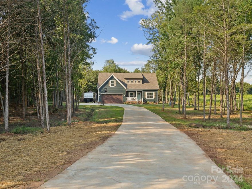 Stunning 4-bedroom home on 3+ acres in Rock Hill. Built only 2 years ago, this gorgeous home is full of custom details: decorative molding throughout, an oversized fireplace, upgraded lighting, a designer kitchen w/ granite countertops, SS appliances, and a decorative backsplash. Experience soaring ceilings in the 2-story great room, kitchen, and dining spaces! Downstairs, the large primary suite awaits w/ dual vanities and a walk-in closet, plus 2 additional bedrooms, a full bath, and the laundry room. Upstairs is the 4th bedroom, 3rd full bath, and an oversized bonus room that can be used as a 5th bedroom, home office, or bonus living space! Outside, enjoy a covered porch, patio w/ fire pit, and the sprawling 3+ acres of property, partially cleared and partially wooded for privacy with a newly designed trail system for ATVs. This home is in the perfect location for outdoor enthusiasts - just across the street from South Street Wake Park and a few minutes from Rock Hill Country Club.