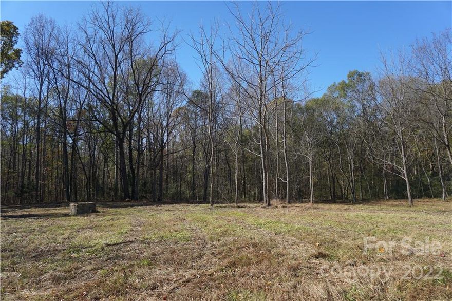 Beautiful 10.64 acre tract of land with mature hardwoods and a flat to gentle rolling topo. This private tract of land has several nice build sites and is located on a cul-de-sac road with minimal traffic. A wide path has been cleared for future use as a driveway. Easy drive to downtown Clover, Lake Wylie, shopping, dining, schools and more!