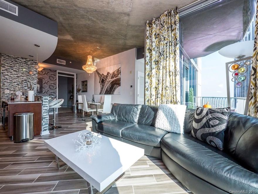 Stunning 31st Floor Corner Condo in the heart of uptown with 2 parking spaces! Completely renovated from floor to ceiling gives it a contemporary feel.The kitchen offers a light granite counter top with tiled walls, stainless steel range hood, double ovens and stainless steel appliances.  Wood design in maintenance free tile is found in entrance, kitchen and great room.  Large w/in shower in master has beautiful stone floor as does guest bath. New closet organizers. New Teak flooring on balcony.