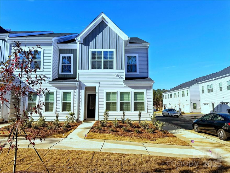 This end-unit Cannalily townhome is thoughtfully designed for today's lifestyle, offering three bedrooms, 2.5 baths, and an open, light-filled layout with upgraded designer touches throughout! The kitchen features Stone Gray cabinets, quartz countertops, White glossy backsplash, large sitting island, stainless steel GE electric appliances, pendant lighting and luxury vinyl plank flooring throughout the main level. The upper level includes a boxed-ceiling primary suite with a walk-in closet and bath complete with dual vanities and a tiled walk-in shower. A nearby laundry closet for added convenience, two additional bedrooms, and a full bathroom complete the second floor. A rear-entry one-car garage and built-in bench and cubby system provide organization and charm. With tasteful finishes and a functional layout, this townhome perfectly balances style and practicality. Minutes from shopping, dining and entertainment! Ask about Move-in package & financing Promotions! 2025 Parade of Homes GOLD Winner!