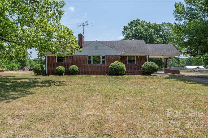 One Level 3 Bedroom, 1 bath Updated Brick Ranch Home. Newly installed vinyl plank flooring and carpet throughout home and freshly painted. As you enter, you are invited into a spacious living room with fireplace and original hardwood paneling. Formal dining room leads into a large horseshoe shaped kitchen with original cabinets. Primary bedroom, other two bedrooms and bathroom on the other side of the home.  Bathroom tub newly glazed, with full bathroom remodel underway. Updated HVAC, insulation and windows throughout home. Full Basement. Small outbuilding in the back, could be used as shed of chicken house. Don't miss this great opportunity to live in Davie County with Great School systems and country setting. Seller plans to parcel up to 1+/- acre to be sold with the home.