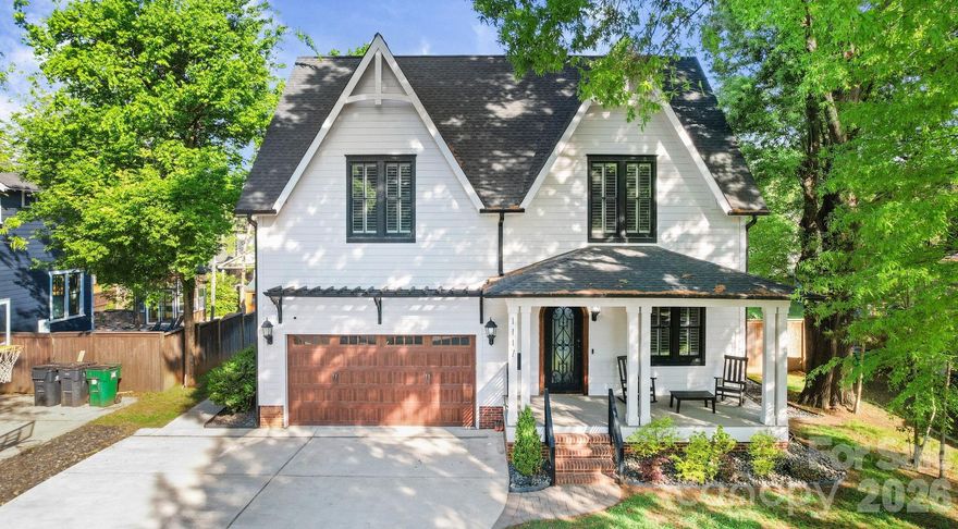 Southern charm, low maintenance, a heated pool, and a fully self-contained apartment — this 4-bedroom, 3.5-bath home in Belmont, Charlotte NC makes a statement from the moment you arrive and keeps delivering. With 2,618 square feet of custom design, a dedicated office, and a 2-car garage, it's walkable to Midwood dining and the Lynx light rail.

The main level opens through a striking wrought iron front door onto beautiful oak hardwood floors. The kitchen delivers: premium GE Monogram appliances, gas range, custom brick backsplash, dry bar with beverage fridge, and a quartz island that seats 8–10. The living room with gas fireplace opens directly to the pool area. Main-level primary suite walks out to the pool with a king bed and custom headboard, built-in closet, dedicated makeup vanity, and a spa-caliber bath with custom mirrors and tile. Office, laundry, and powder room complete the ground floor.

Outside: 12×25 heated pool finished in 2023, large pool deck, gas grill hookup, firepit hookup, and Ultra Aluminum privacy fencing needs no maintenance. Front irrigation and triple-wide driveway. 
Upstairs, 2 bedrooms share a full bath, each with oversized walk-in storage and city views. The 700 sq ft attached apartment has its own private entrance, full kitchen, bedroom, full bath, living area, and washer/dryer — ideal as a rental, in-law suite, multigenerational living space, or second primary suite. An interior door connects it to the main house and can be locked or open. Solid throughout: 3-zone HVAC with a dedicated apartment zone, tankless water heater, full CPI security system, wrought iron interior staircase, and extra-deep 2-car garage with sink. Washer/dryer new in 2024. Exterior fully painted in 2021. Move-in ready.