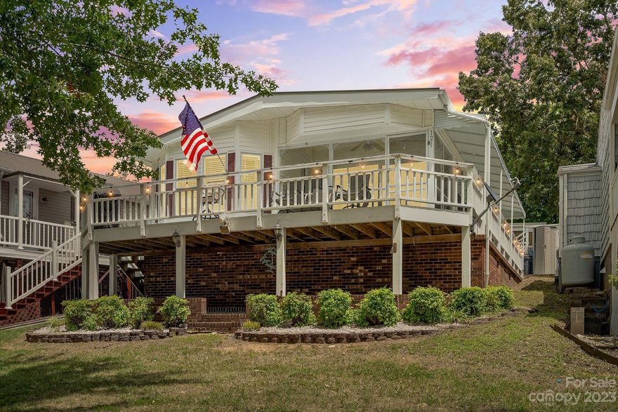 WATERFRONT......Lake life is waiting for you in this Waterfront 2 bedroom 1 & 1/2 bath park model home with room addition. Come enjoy sitting on your deck watching the boats go by. If the weather is a little chilly...no problem because you have great views from inside the living area or on your enclosed porch.  This property offers a nice level lot only steps to the boardwalk with a convenient location to walk to the sandy beach /swim area or the marina/boat ramp/restaurant. Buyer of this property has the first option to purchase separately a 30" boat slip with new lift that will accommodate up to a 28" pontoon boat. The property also offers concrete area for parking and a storage building that will fit most golf carts or side by sides. Badin Shores Resort offers many amenities that include a swimming pool, boat ramp, clubhouse, waterfront boardwalk, playgrounds, picnic areas/pavilions, basketball court, putt putt, sand volleyball, RC track, sandy beach & lake swim area, & more.