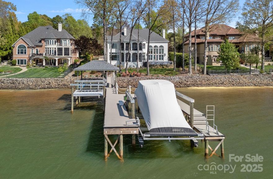 Incredible views of SUNSET FOR MILES in the GATED WESTVIEW community off the Langtree Exit! GORGEOUS UPGRADES! Charming painted brick home with all systems updated. Move in and enjoy relaxation and entertainment in your new home! Beautiful hardwood floors lead to towering windows overlooking LAKE NORMAN in the grand 2 story living room! Full bath on main level provides a guest suite. The gourmet kitchen boasts Wolf appliances, quartz countertops, and opens to a screened patio. Three fireplaces enhance the ambiance throughout. Gracefully curved staircase guides you to a state-of-the-art theater room for more enjoyment, accompanied by an additional bonus space. The newly remodeled primary suite offers a sitting area and a screened porch. Upper level has three additional bedrooms, one ideal for an office with water views. Outdoor areas also feature surround sound and an infinity-edge saltwater spa/pool completing this idyllic retreat. Refer to  attached additions sheet for more details.