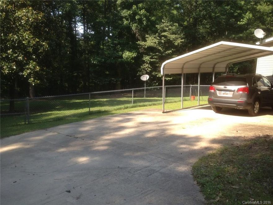4.33 acres in rapidly growing Indian Land.  Mobile home, fenced in rear yard, outbuilding, carport included at no value.  Additional parking in driveway.  NO owner financing !