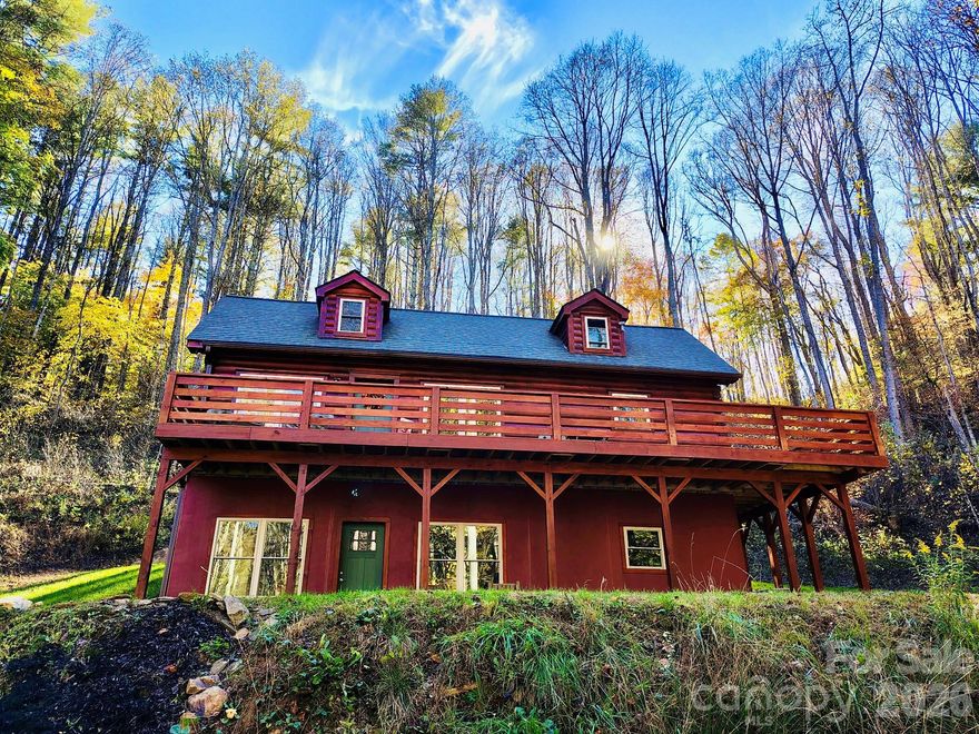 Nestled in the heart of the Blue Ridge Mountains, this 2023-built private log home sits on 4.5 acres near the picturesque Town of Burnsville, in Yancey County - the home of Mount Mitchell. The sunlit living space feature pine floors, vaulted ceilings and an open-plan layout perfect for entertaining after a day on the trails. The kitchen showcases quartz countertops and stainless appliances. The primary suite offers a walk-in closet and private full bathroom. A second bedroom accommodates two guests. A loft adds flexible sleeping space for additional guests. A second full bathroom provides additional comfort. The insulated daylight basement doubles the usable area. A RV pad with electricity greets more guests. The spacious panoramic deck frames mountain views, wildflower meadows and gentle creeks. Extras include privately-owned road, spring and reservoir, septic and underground utilities, water rights, and storm-resilient construction. Make this gem your Dream Mountain Retreat now!