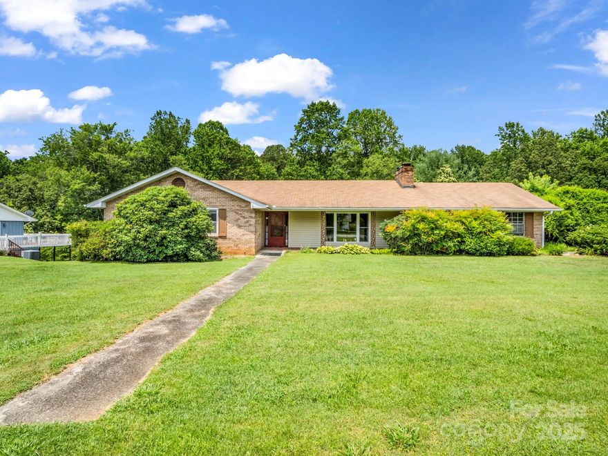 Owner will provide Home Warranty with accepted offer!  Don't miss this opportunity! Beautiful ranch style home on just under 2 acres in a well-established community. Home features 3/2 home, kitchen/den area with pocket doors to close off from living room, includes French doors to deck overlooking the spacious lawn leading to a shady trees with a creek. The living room offers a floor to ceiling picture window and a  fireplace with a wood stove for extra heat and attic fan for cooling when the AC isn’t needed. All bedrooms have large closet space and home offers additional coat closet, linen closet and a large cedar-lined closet for winter storage. Full unfinished basement with partially gutted area for renovation, perfect for an Airbnb/mother-in-law apartment. Basement features a workshop/ garage, laundry area, lots of shelving & plumbed for an additional bathroom w/cabinetry & jacuzzi tub already purchased. You’ll love the carport and adjacent shed.  Less than a mile to I-40 access and within minutes of dining,  community playground and Buncombe County Sports Park