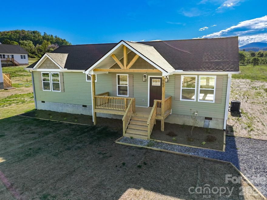 Experience modern mountain living in this brand new construction home ideally located a short drive from downtown Hendersonville. Enjoy outdoor adventures with nearby hiking trails, waterfalls, and apple orchards. Inside, the open floor plan is bathed in natural light, perfect for entertaining. The spacious primary suite boasts a walk-in closet and an elegant bath with dual vanity and custom tile shower. Luxury vinyl plank flooring flows throughout, complementing the kitchen’s stainless steel appliances, granite countertops, soft-close cabinets, and a large island. Step onto the spacious deck and breathe in the crisp mountain air. With thoughtful design and a peaceful setting, this home is ideal for year-round living, a weekend retreat, or an investment property. Experience the perfect blend of comfort, style, and nature! *Potentially up to $2,500 in closing credit*