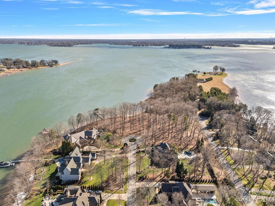 Do not miss out on this incredible lakefront peninsula lot opportunity in The Point! This is an extremely rare offering as it is two lots (192 & 193 Shelburne) that can be combined to allow for a luxurious waterfront home or remain as two separate buildable lots. Combined, the 2.52 acres would allow for an expansive estate residence with a multi-car garage & provide-long range main channel views. Located at the end of a cul-de-sac, these flat lots offer privacy & are ideal to build on. There is 256 feet of shoreline with a beautiful stone seawall & sandy beach area. A 120-foot aluminum pier is in place with a floating dock, 20,000 pound boat lift & 2 jet ski lifts. The amenities at Trump National Golf Club Charlotte offer resort-style living that is unmatched. Build your dream Lake Norman estate on one or both lots!