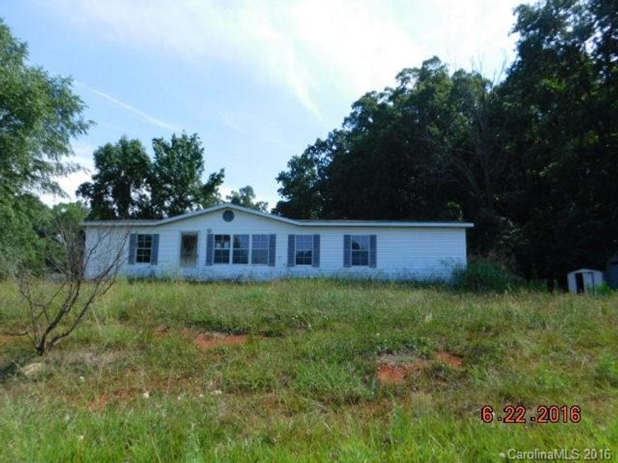 Manufactured doublewide home with 3 bedrooms, 2 baths, kitchen and living room. Features spacious rooms and  master bathroom has double sinks and garden tub. Home has deck and some mature trees at the back.