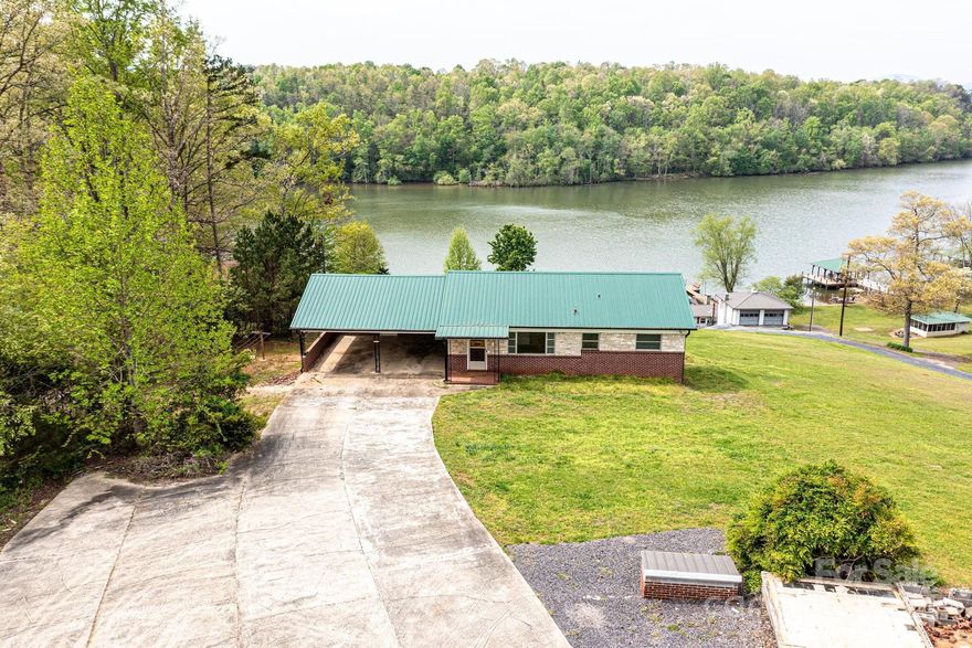 WHAT A VIEW you will have from this WATERFRONT property priced under $500k!  Located on Lake Hickory with wide open views, this single level with daylight/walkout basement would make an amazing weekend get-a-way or purchase for investor buyer!  The opportunities are endless!  Featuring 3BR/1BA on the main level with a large living room and kitchen.  In addition, the basement offers a 2nd kitchen with a large living space, full bathroom and bedroom.  The deep lot slopes gently to the lake with 108 feet of shoreline with a beach area and an old boathouse!!  Enjoy skiing, boating, fishing, fireworks from The Crawdads stadium, etc.!!!  "Selling "As-Is". 
The seller will make no repairs.  No city taxes or HOA. Conveniently located to Hickory's Riverwalk/City Walk, an easy drive to the mountains and roughly an hour to The Charlotte Douglas Airport!