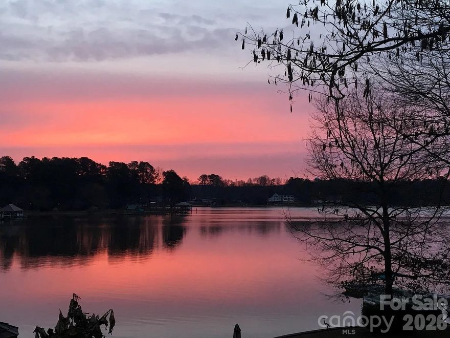 Rare Waterfront opportunity on Lake Norman with no HOA! Lakefront home situated on a peaceful 0.73-acre lot, 179 feet of shoreline, long-range water views, and gentle topography with easy access to the lake. Home offers single-level living with 2 bedrooms, 2 baths, plus a large third room currently used as a bedroom with lake views. Water views from primary, second bedrooms, and living area w/vaulted ceilings. The property features a private covered dock with a lift, an additional floating dock/lounge platform, and a sandy beach area. Ideal for boating, kayaking, swimming, and relaxing by the water. Outdoor living spaces include a large deck, a screened four-season porch, a raised tree deck overlooking the lake, a gazebo sitting area off the pier, a fire pit, and a beautifully landscaped yard with mature trees, flowering plants, and fruit trees. Additional features include an encapsulated crawl space, an insulated workshop under the deck, an irrigation system, a 10x12 shed, a 2-car carport, 3+ parking spaces, and a rocking chair front porch. This well-maintained property provides exceptional flexibility. Turnkey- ready to enjoy today, weekend retreat, perfect for a renovation project, or future new construction. Located in one of the most desirable and quiet areas of Lake Norman on the Brawley School Peninsula. Close to shopping and restaurants. Quick access to I-77, Davidson, and Charlotte, this is a rare chance to own waterfront property with unrestricted use. Must see- property offers outstanding potential in a prime Lake location—Pre-approval for viewing today. Opportunity-Seller is selling adjacent lakefront home/lot