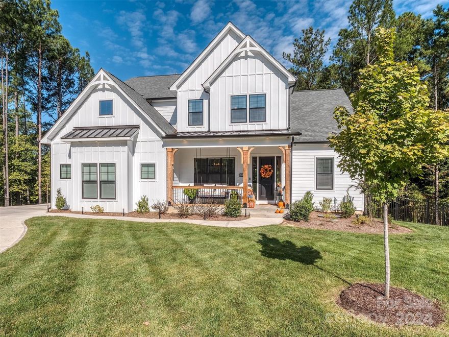 2022-built modern farmhouse style 2-story/basement home loaded with highly-customized finishes & open floor plan. LAKE-AREA LIFESTYLE in Handsmill on Lake Wylie, a full-amenity neighborhood with gorgeous pool, clubhouse, fitness, PRIVATE ACCESS COMMUNITY BOATRAMP, WET & DRY BOAT/RV STORAGE. Enjoy a wooded backdrop on the $80,000 2-tier 1200-sf deck overlooking the .75 ACRE CUL-DE-SAC LOT, or the covered porch off the main level living areas. Distinctive features include contemporary gas FP, sleek stair case, full-installation KitchenAid fridge & appliance package, double ovens, coffee bar, beverage cooler, gleaming island w pendant lighting, extra freezer in 5x12' walk-in pantry, mudroom. PRIMARY BDRM ON MAIN has organized closet & stacked W/D. Upper bedrooms have direct bath access & walk-in closets. Huge lower level, full bath, 3 storage areas, 700 sf easy-CONVERSION space has HVAC for 5TH BEDROOM/PRIVATE OFFICE. Excellent CLOVER SCHOOLS,  quick accessibility to Charlotte & airport.