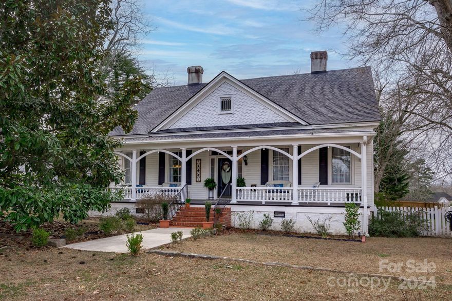 Elegant and beautiful where classic appeal meets modern comfort. Over 2700sf, this historic gem offers an irresistible blend of elegance and functionality. The spacious foyer is flanked by formal living & dining rooms, classic hardwood floors, moldings, and lofty ceilings. Tall windows allow the sunlight to enhance ambiance. The kitchen features freshly painted cabinets, modern appliances, and a new tile backsplash, combining. The sunroom invites relaxation or use as a guest bedroom. A main floor bedroom & den offer versatility for various lifestyle needs. Upstairs, a spacious bedroom awaits, complete with a private bath and newly upgraded shower. A fully fenced yard and back patio create the perfect outdoor setting for. Convenient to major cities like Columbia, and Charlotte, make commuting a breeze. Enjoy outdoor exploration, from Lake Wateree to the Palmetto Trail. Discover the comfort of this historic treasure, now back on the market after upgrades to the kitchen and master bath.