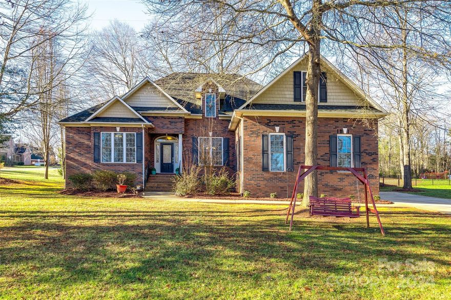 This pristine, primarily brick home, located on a corner lot in Patrick Place, is ready to move in. The great layout features a primary bedroom & bathroom with a whirlpool tub, large walk-in tiled shower, and double vanities. Also find a desirable 2nd bedroom & bath on the main floor. The open floorplan seamlessly connects the great room, kitchen and dining area, making it ideal for hosting guests. The craftsmanship is evident throughout with custom trim, moldings, and tray ceilings. The kitchen boasts a breakfast nook with bar seating. Outside, a back deck overlooks a fenced backyard, perfect for children or pets. Upstairs, there is a bonus room, full bathroom, a 3rd bedroom, and an extra room currently used as an office. The property features a side-load 2-car garage and a double wide driveway offering ample parking space. Award-winning Clover Schools, low SC Taxes, and easy access to Rock Hill, Charlotte, and Gastonia for shopping, dining, healthcare, local boat ramps, and marinas.