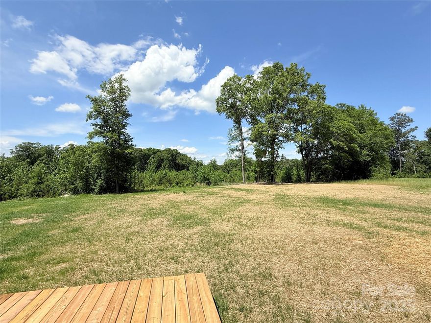 New Construction on 16+ Acres in Lancaster, SC!  From the moment you arrive, the arched entry and covered front porch offer charming curb appeal and a warm welcome. Inside, the open-concept floor plan is enhanced by elegant crown molding and recessed lighting, creating a bright, custom feel throughout. The kitchen serves as the heart of the home, featuring a large island with bar seating—perfect for everyday living and entertaining.  This thoughtfully designed 3-bedroom, 2-bath home includes a spacious primary suite with a walk-in closet, dual sinks, and a walk-in shower. A generous laundry room with built-in storage adds functionality, while the 2-car garage provides plenty of space for vehicles and gear.  Step out back to relax or entertain on the rear porch, and enjoy the endless potential of 16+ private acres—ideal for gardening, exploring, or future expansion. A rare opportunity to enjoy space, style, and serenity—all in a convenient Lancaster location.