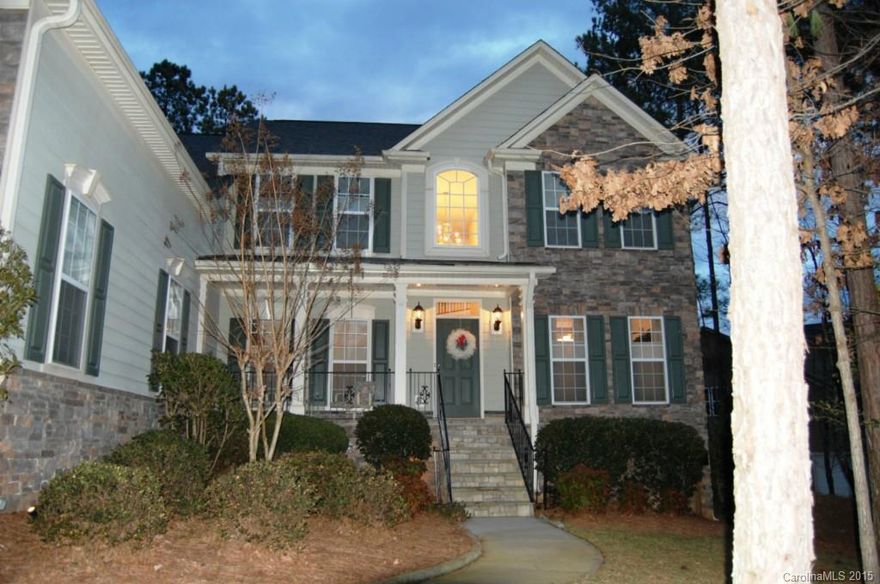 Beautiful two story home in gorgeous neighborhood with plenty of amenities and easy access to Mountain Island Lake.   Kitchen has cherry cabinets, stainless steel appliances & granite countertops.  Lovely breakfast/sunroom. Master down with his/her walk in closets and split double vanity. Large bonus room upstairs that could be a fifth bedroom.  3 car gar. Private wooded lot with natural areas in the front and back. Amenities include pool, tennis, clubhouse. Close to shopping and the airport.