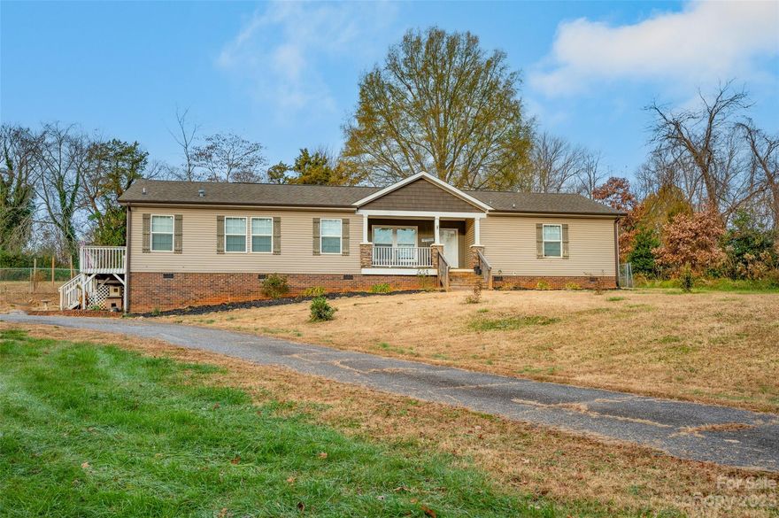 This home offers over 2,000 square feet and updates galore. You will love the spacious kitchen that features an oversized island, farmhouse sinks, and a convection wall oven. The large primary suite is complete with soaker tub, dual walk-in closets, custom bamboo sinks, and a laundry shoot. Amazing floorpan with spacious rooms and tons of windows that allow ample natural light. The wood-burning fireplace in the living room is perfect for cooler winter evenings. Beautiful granite countertops throughout home. With fresh paint and new carpet, this home is truly move-in ready. A whole home water filtration system was also installed. Sitting on over an acre of land, this home is located on a dead end street and offers a large fenced yard with a french-drain system in back yard. If privacy is what you are looking for in a convenient location that is close to town, then this home is the one for you!