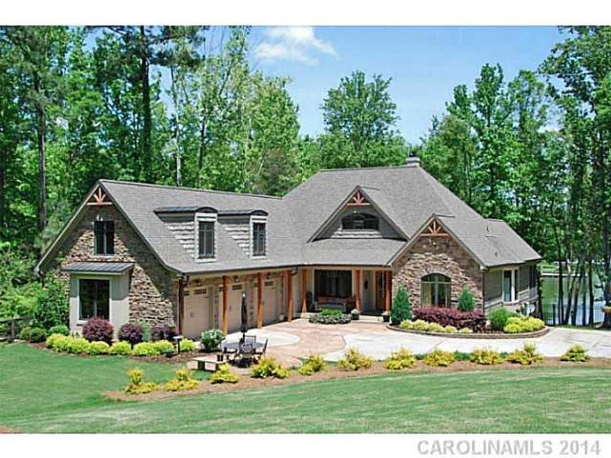 Exceptional waterfront home with features sure to delight: gorgeous lake views, Chinese teakwood wood floors, dome ceiling in keeping room, natural stone fireplace, two master suites and a gourmet kitchen. Luxury master bath w/ sauna & whirlpool! Professionally landscaped yard, fenced w/ private security gate. Dock with lift.  Huge rec room + bonus room for office or add'l living.  See tour!