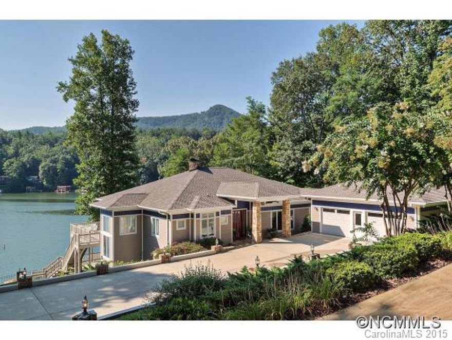 Spacious Custom Lakefront Estate on Main Channel.Level Lawn to lake. Sandy Beach. Expansive paved Parking. Stonework. Double Boathouse. Electric Lifts. Sundeck. MOUNTAIN & LAKE VIEWS. Double LAKESIDE DECKS. Lakeside Screened Porch.Open Floor Plan. 2 STONE FIREPLACES. Cathedral Wood Ceiling in Main Level Great Room. Casual Dining plus Formal DR. Office with Built-ins. Storage. Pantries. Ideal Entertaining. Wet Bar.