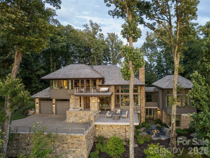 Located within the exclusive gated community of The Cliffs at Walnut Cove, the residence at 8 Deer Grass Court, known as “The Perch,” is a masterwork of contemporary design situated atop Chestnut Top Mountain. This 7,277- square-foot retreat was intentionally constructed to immerse its inhabitants in the natural landscape, utilizing slender steel architecture and expansive windows throughout create a seamless visual experience—framing breathtaking views of sunrises and sunsets—and a serene environment flooded with natural light. The interior is defined by a warm living space and a meticulously detailed kitchen, all connected by a striking floating walnut staircase. Unique architectural elements, such as a wide, light-filled interior bridge, connect the primary suite to the main living areas, while the outdoor balconies offer panoramic views stretching from Mount Pisgah to the skyline of Downtown Asheville. Artfully landscaped grounds feature a curated mix of perennials and evergreens for year-round interest with minimal upkeep.The home is equipped with sophisticated modern technology, including a Lutron lighting system, geothermal heating and cooling, and motorized shades in every room to manage the abundant natural light.

With a Cliffs membership, residents of The Cliffs at Walnut Cove enjoy access to a world-class lifestyle centered around an 18,000-square-foot wellness center featuring indoor and outdoor pools, tennis courts, and a luxury spa. The community’s crown jewel is a Jack Nicklaus Signature golf course, which is complemented by an award-winning clubhouse and "The Tavern," a social hub for fine dining and member events. Bordering the Pisgah National Forest and located just minutes from the Blue Ridge Parkway and Asheville, this property offers a rare combination of high-altitude privacy and convenient access to premier cultural and recreational amenities.