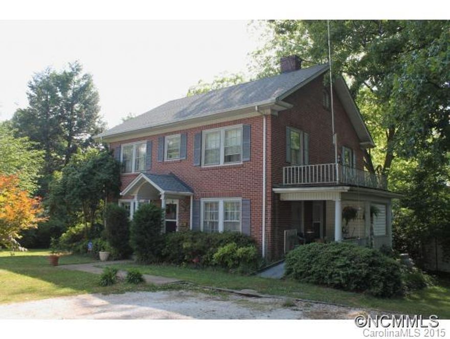 Spacious Brick Colonial within walking distance  to Downtown Spindale. Charm & character inside & out. Wood floors, 10' ceilings, LR w/FP & door to side veranda, formal DR, eat-in kitchen w/breakfast area, 1st floor LA (great cabinet space & door to small deck), 1st floor MBR with FP & walk-in closet, walk-in closets in all upstairs rooms, workshop in basement, private fully fenced backyard, large outbuilding, and security system. New heat pump.