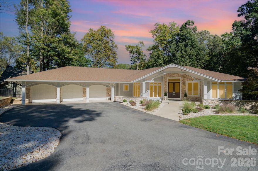 This pristine thoughtfully designed three bedroom plus flex room waterfront retreat offers beautiful year round views from multiple levels, where morning light and sunset reflections become part of everyday living. The main level features an open concept design anchored by a chef’s kitchen with high end appliances and a bonus dedicated beverage refrigerator and freezer, wine refrigerator, and coveted Miele coffee system. The primary suite on the main level is a true sanctuary with a spa like shower, soaking tub, and private balcony access to enjoy those peaceful mornings and glowing sunsets.The lower level offers two additional ensuite bedrooms with spacious walk in closets, a second living area with wet bar, and direct access to the outdoor living space. Outside, a newly converted saltwater infinity pool overlooks the water, complemented by an outdoor kitchen, bar and dining area, creating a private resort atmosphere. Meticulously maintained with many very recent improvements, this home comes with a new septic system, new buried propane tank, new water softener, new gutter guards, new under deck ceiling, updated landscaping, new exterior doors, new lower level luxury vinyl plank flooring, and is freshly painted throughout. Located off Brawley School Road for convenience this beautiful home’s location is the end of a shorter cove for quick main lake access and better dock preservation, all set on a wonderful 1.66 acre lot with no HOA.