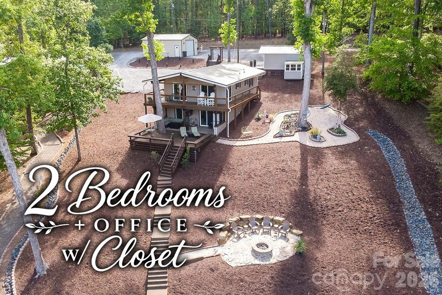 Elevated lake living with immediate income potential! Fully turnkey, short-term rental friendly, and ready to enjoy from day one! Exceptionally renovated and fully furnished lakefront residence on Lake Tillery, set on a ½-acre double lot with approximately 150 feet of pristine shoreline in a deep 12–14 ft cove. This thoughtfully designed home features 2 bedrooms, 2 updated baths, and a versatile bonus room with closet making it ideal for office, guest space, or additional sleeping area.

Extensive recent upgrades provide peace of mind and modern comfort, including a new metal roof (2025), updated electrical breaker box (2025), new front door and frame (2025), new sliding doors (2025), and all-new water lines from street to home and exterior spigots (2025). Both bathrooms were updated in 2024, and the kitchen was renovated in 2022 with Whirlpool appliances, all three years old or newer.

Outdoor living rivals the interior, featuring a new upper deck (2025), lower deck with stairs to the boathouse (2020), custom fire pit, and a serene zen hammock area overlooking the water! A 150-ft seawall with swell protection (2023) enhances shoreline durability and aesthetics.

The wired boathouse includes a pontoon lift and Seadoo drive-up pad, with buried electrical line installed in 2020. Additional structures include a 608 sq ft wired garage with roll-up door and a 346 sq ft wired shed with lean-to. Double driveway offers generous parking for all!

Offered completely furnished inside and out including kitchenware, TVs (including garage TV), linens, towels, and décor! Don't miss out on this amazing opportunity!