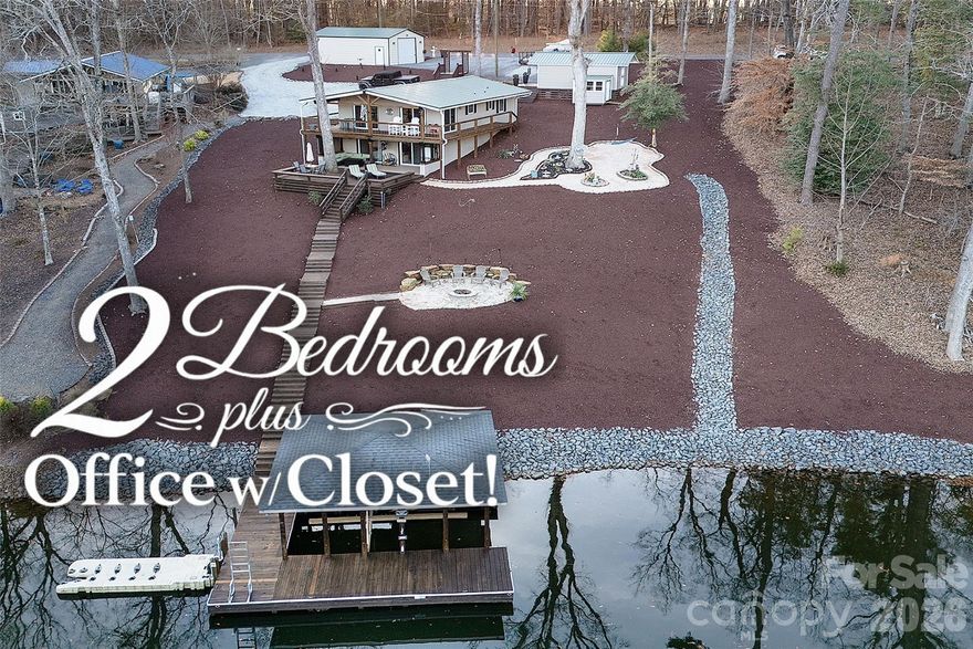 Elevated lake living with immediate income potential! Fully turnkey, short-term rental friendly, and ready to enjoy from day one! Exceptionally renovated and fully furnished lakefront residence on Lake Tillery, set on a ½-acre double lot with approximately 150 feet of pristine shoreline in a deep 12–14 ft cove. This thoughtfully designed home features 2 bedrooms, 2 updated baths, and a versatile bonus room with closet making it ideal for office, guest space, or additional sleeping area.

Extensive recent upgrades provide peace of mind and modern comfort, including a new metal roof (2025), updated electrical breaker box (2025), new front door and frame (2025), new sliding doors (2025), and all-new water lines from street to home and exterior spigots (2025). Both bathrooms were updated in 2024, and the kitchen was renovated in 2022 with Whirlpool appliances, all three years old or newer.

Outdoor living rivals the interior, featuring a new upper deck (2025), lower deck with stairs to the boathouse (2020), custom fire pit, and a serene zen hammock area overlooking the water! A 150-ft seawall with swell protection (2023) enhances shoreline durability and aesthetics.

The wired boathouse includes a pontoon lift and Seadoo drive-up pad, with buried electrical line installed in 2020. Additional structures include a 608 sq ft wired garage with roll-up door and a 346 sq ft wired shed with lean-to. Double driveway offers generous parking for all!

Offered completely furnished inside and out including kitchenware, TVs (including garage TV), linens, towels, and décor! Don't miss out on this amazing opportunity!