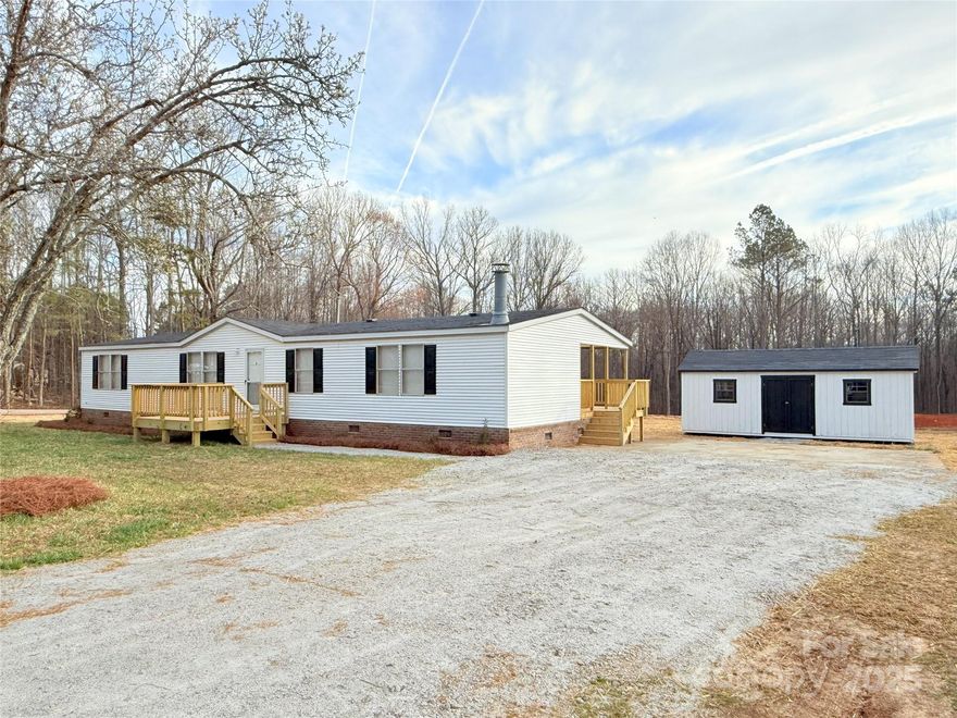 If you’ve been searching for the perfect mix of country charm and full of updates, congratulations—you just found it! This 3 bed, 2 bath beauty is sitting pretty on 1 full acre, giving you plenty of space.  Inside, you’ll find an open-concept den, dining, and kitchen area with a sliding glass door leading to a covered porch.  The primary suite is like a mini spa retreat, complete with double sinks and a stand-up shower. Updates to include: new HVAC, roof, appliances, light fixtures, plumbing fixtures, water supply lines, decks, doors (inside and out), blinds, and flooring!  There's also 12x24 storage building—whether you need a workshop, man cave, she-shed, or just a place to hide out.  This home has almost 1800 sq feet and is zoned for Buford schools!  Now is the perfect time to call 288 John L Hudson Sr. Rd home!