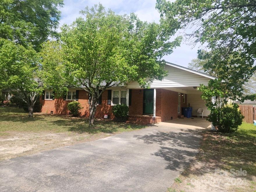 Don't miss this brick ranch, located on a spacious lot, in the heart of downtown Pageland!  It features a large living room, kitchen/dining combination, that leads to a rear sun porch and laundry room.  There are three bedrooms and two full bathrooms.  The spacious back yard is surrounded by a privacy fence and features a concrete patio area and storage building. There is an attached carport.