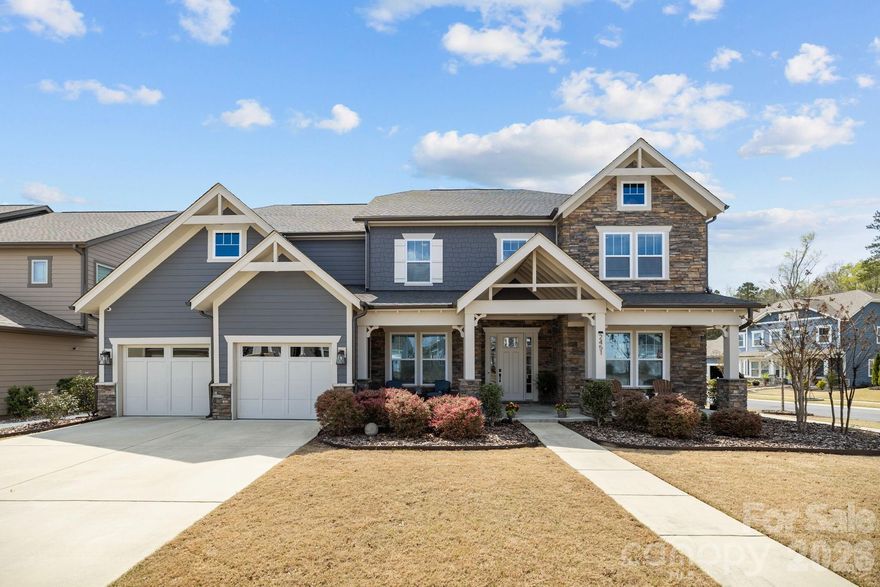 Welcome to this stunning home at 2451 Paddlers Cove Dr. located in the highly sought-after Paddlers Cove community of Lake Wylie. Built in 2020, this Luxurious two-story residence offers approximately 4,356 sq ft with 5 bedrooms and 4.5 bathrooms, designed for comfortable living and effortless entertaining. 
The open-concept main level features a bright great room with a linear gas fireplace that flows into a chef’s kitchen complete with quartz countertops, stacked cabinetry, a large island, KitchenAid 5 burner gas cooktop & wall oven, prep kitchen, and walk-in pantry. A main-floor guest or in-law suite provides the perfect space for visitors or multigenerational living and you don’t want to miss the light-filled 3 season sunroom just off the living room.  
Upstairs, the spacious primary suite offers a private retreat with an oversized spa-style shower, dual vanities, and walk-in closet, while three additional bedrooms, a large bonus room, and an upper-level laundry room provide plenty of flexibility for family, guests, or work-from-home needs. 
Situated on a corner fenced lot, the home also features a 3-car tandem garage and inviting outdoor living spaces, including a covered front porch and a covered back porch with stone fireplace perfect for relaxing or entertaining. Aquasana whole house water filtration system, Rinnai tankless water heater & EV charger in Garage. 
Paddlers Cove residents enjoy access to the community’s resort-style amenities including pool, playground, sports courts, picnic areas, and lake access with a paddle launch, all just minutes from shopping, dining, the waterfront lifestyle of Lake Wylie and Charlotte.