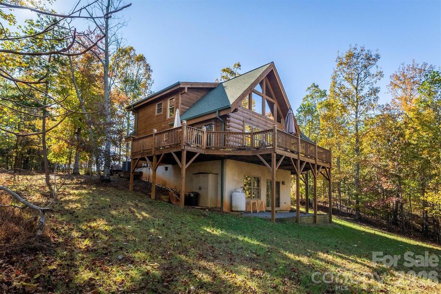 Rustic Log Home on 2.4 acres offering long-range mountain views and all the natural serenity that the Blue Ridge Mountains are famous for. Offered Partially Furnished! Located in the popular gated community of Grandview Peaks, this home offers 3 levels of living space with 2 bedrooms and 3 full baths including one in the finished basement - the perfect setting for a second family room, home gym, or man cave/game room. The land has a gentle slope, providing ample space for outdoor living, gardening, or simply relaxing in nature.  The covered gable front porch and open decks on two sides offer lots of space for grilling, lounging, or entertaining friends. Inside, the family room has high ceilings, centered around a gas log fireplace. There's both a dining area and a breakfast bar off the kitchen island to accommodate many visitors. The kitchen is open with wood cabinets & stainless steel appliances. Bathrooms are spacious with tile showers & lots of storage. The primary bedroom is upstairs with an en-suite bathroom, walk-in closet, and a loft overlooking the family room - the perfect spot for a home office or hobby space. The finished basement offers a huge open den, the perfect spot for a movie night or to watch the big game. It would also make a fantastic game room or extra sleeping space for guests. The laundry room is located in a large utility room with lots of storage space. This home has been partially used as a short-term rental with a great rental history. The community offers miles of hiking trails and a small stocked lake for swimming, fishing, or kayaking. Next to the lake is a white sand beach, a floating dock, 2 stationary docks and a large heavy timber pavilion for picnicking and neighborhood gatherings. Come see all this wonderful mountain home and community has to offer!