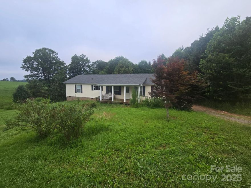 Peaceful 3-acre property featuring a classic ranch home, perfect for those seeking quiet living with room for outdoor hobbies or animals. 3 bedroom 2 full bath, featuring a cozy fireplace, extra large covered carport, and spacious back deck to enjoy gatherings and gorgeous country views.