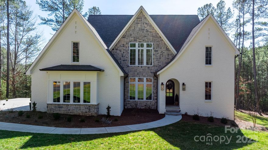 Outstanding home in prestigious , gated community of Anchors Landing. Enjoy the tranquil privacy overlooking a small interior lake! This home has so much to offer including custom cabinetry, marble countertops and hardwood flooring throughout. Unwind after a busy day while sitting on the covered patio watching TV or enjoy sitting by the fireplace looking out over the water. Primary bedroom suite is on the main level giving you lots of privacy. Second floor offers 2 bedroom suites with walk in closets and baths. Huge recreation room and a bonus room for movie night!