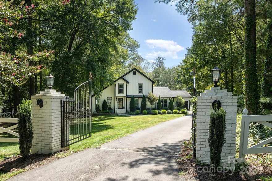 This modern farmhouse in Indian Land is a dream for equestrian lovers! Set on over 3 acres, this home features a gated, private drive,heated and air conditioned garage, large barn for horses, workshop or storage. The community offers equestrian facilities, clubhouse, walking trails, tennis courts, pool, and 2 stocked fishing ponds. LVP floors throughout, vaulted ceilings in the living room, multiple fireplaces, and a screened-in porch. The updated kitchen has quartz countertops, a prep island, farmhouse sink, and appliances recently updated in 2021. Primary bedroom is conveniently located downstairs and a beautiful wrought iron staircase leads to a loft area upstairs, perfect for flex space. The outdoor space is equally impressive with a swing set, hot tub, fruit trees, blueberry bushes, and 15 organic chickens actively laying farm-fresh eggs. With a prime location close to Ballantyne and near shopping, dining, and top-rated schools in Indian Land, this home is a must-see!