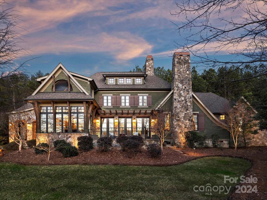 Experience life on a permanent retreat in this award-winning custom home in the gated community Pinnacle Ridge. It feels like a hideaway, with so many architectural details… starting with the inviting covered stone front porch. Inside, you’ll find a chef’s kitchen with dual breakfast bars that open to the family room which features a soaring beamed ceiling and stone fireplace. A cozy rear screened porch overlooks the saltwater pool, cabana with stone fireplace, and turfed backyard with putting green. The family room, kitchen and breakfast area overlook the stunning terrace for evening sunsets.  Primary suite on the main features a stone fireplace and a separate lounge that could be used as an office or nursery. An additional bedroom on the main is an added bonus. Upstairs, includes a loft area with overlook that leads to a peaceful sleeping porch, along with an additional bedroom and a bonus. Incredible guest suite over the garage. The possibilities are endless in this lifestyle home!