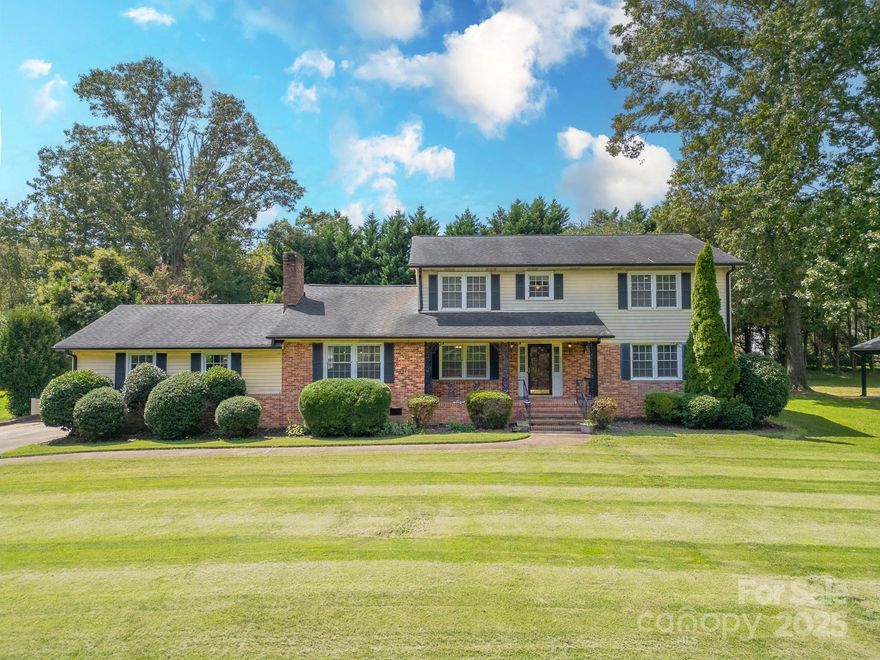 Welcome home to this beautifully maintained 5-bedroom, 3.5-bath colonial in one of Bessemer City’s most established neighborhoods. Designed with both space and comfort in mind, this home offers formal dining room and living area in addition to a main-level primary suite. The second floor includes four oversized bedrooms with hardwood floors and two full baths, providing room for everyone. At the heart of the home, the great room features rare teak wood flooring, wooden beams and a dramatic fireplace, perfect for gatherings or entertaining. A spacious kitchen with new granite and quartz counter tops with nice sized breakfast area. New engineered hardwood flooring in main living and dining areas and new paint in many of the rooms. Back yard is fully enclosed by a custom brick fence. Newly added sunroom addition allows tons of natural light. New gutters and gutter guards installed. Other upgrades include tankless water heater, whole house filtration system and reverse osmosis in kitchen. Located just minutes from Crowders Mountain State Park, I-85, Charlotte-Douglas International Airport, shopping, and dining. Seller is offering 1 year home warranty.