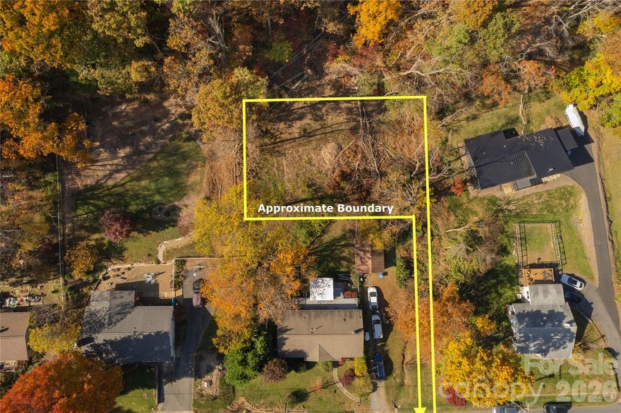 Premium North Asheville lot, instantly ready; just add water—no pun intended! Located on a quiet street with a picturesque setting and mountain views, you'll love it here. This lot is less than 15 minutes from downtown Asheville, in the coveted Beaverdam Valley, offering the perfect blend of natural beauty and modern convenience. Come join this pleasant street in a beautiful area. With a well-prepared build site/driveway, city sewer & water, survey, and no HOA's, all that’s needed is your dream home! See attached details, the sellers have done their due diligence to make this as simple as possible for the buyers!