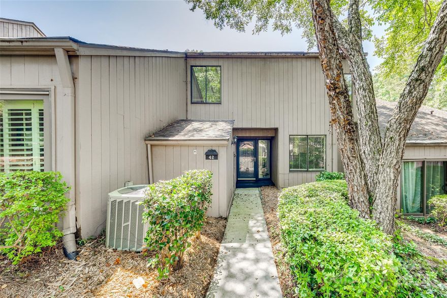 Experience resort-style living every day in this newly renovated, bright, and roomy condo located in the sought-after gated community of River Hills! The condo features fresh paint, new carpet, and a neutral color palette throughout. The impressive two-story Great Room boasts a gas log fireplace and sliding doors leading to the patio. A versatile front room perfect for a Den/Office. The kitchen showcases new cabinets, stove, and countertops, offering ample storage and prep space. The spacious dining room also connects to the patio, ideal for entertaining or unwinding. The primary suite is generously sized with abundant natural light, a dressing area with spacious closets, and a lovely ensuite full bath. Enjoy the serene wooded surroundings and direct access from your back door to the private pool exclusively for Bluff's residents. This location is in the heart of Lake Wylie, close to shopping, upscale dining, and top-notch schools. Pets conditional. **No Cats.**