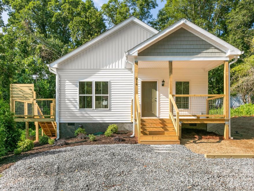 Tucked away on a private lot in the growing Candler area just minutes from Asheville, this single-level new construction home offers the perfect blend of comfort, style, and low-maintenance living. Designed with an open, airy layout and filled with natural light, the home feels calm, welcoming, and easy to live in. The kitchen features granite countertops, a farmhouse sink, and a seamless flow into the main living space—ideal for everyday living or gathering with friends and family. The spacious primary suite includes a large bedroom, generous closets, and a beautifully tiled walk-in shower. Enjoy the convenience of one-level living with durable, modern finishes and blinds throughout. Step outside to a private deck overlooking a peaceful wooded setting—perfect for relaxing after a long day. A rare opportunity to enjoy new construction, privacy, and convenience at an attainable price.
