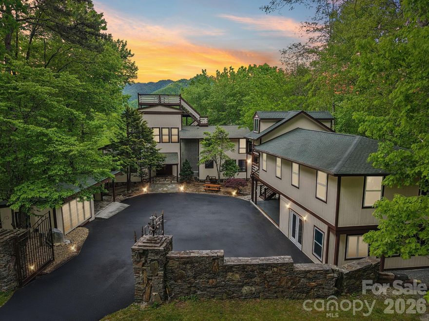 A once-in-a-generation opportunity to own one of the most architecturally iconic and storied estates in the Great Smoky Mountains.

This legacy estate in Nantahala was originally built in 1985 for executives of the legendary Record Bar Company and built by renowned builder Bill Baxter. The extraordinary circular residence was intentionally crafted in the shape of a vinyl record—centered around a dramatic, floor-to-ceiling stone fireplace that anchors the entire home.

Set in a premier Nantahala location just minutes from the Nantahala Outdoor Center, Appalachian Trail access, and Fontana Lake, the property offers unmatched access to whitewater rafting, hiking, and mountain adventure, while remaining privately tucked among national forest land where deer and native wildlife roam freely.
Spanning over 6,500+ square feet, this estate blends architectural significance with modern luxury. Expansive glass, soaring ceilings, and open-concept living spaces frame breathtaking long-range mountain views in every direction.

This home features signature circular design with central stone fireplace, four deluxe suites with spa-inspired baths, a roof top observation deck with panoramic Smoky Mountain views, new flooring, paint, lighting, and upgraded finishes, a Sauna, outdoor hot tub, wellness-focused amenities, a wet bar and open entertaining spaces designed for hosting.

Imagine living in this private mountain resort with extensive, wraparound and terraced decking, the rooftop terrace, covered outdoor lounges, firepit gathering areas and an immersive forest setting full of views, stone pathways and curated landscaping throughout.

Own your own detached, fully upgraded gym and entertainment building, complete with new roofing, high-end equipment, and its own climate system.

Whether envisioned as a private luxury estate, corporate retreat, boutique rental compound, or legacy family property—this offering is simply irreplaceable.

Private Luxury. Iconic design. Unmatched setting.