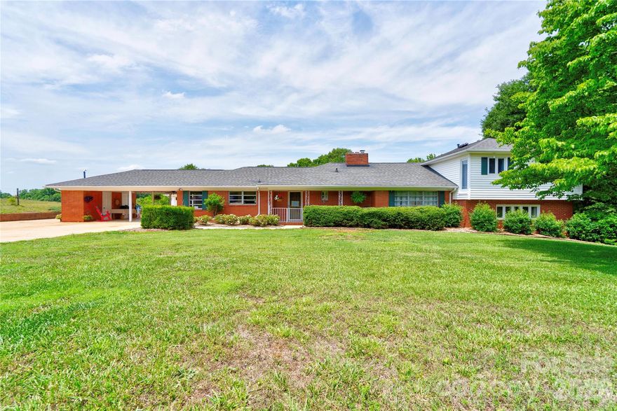 Situated on approximately 2.7 acres, this spacious 3-bedroom, 3-bath split-level home offers room to spread out both inside and out. The thoughtfully designed floor plan features a large living room with a gas log fireplace, a separate dining room, and a spacious family room highlighted by a unique retro fireplace, creating multiple areas for relaxing and entertaining.  The kitchen is full of character with distinctive live-edge countertops, a breakfast bar, and a cozy breakfast nook. A large laundry room adds convenience and extra storage space.  The private primary suite is tucked away on the upper level, offering a peaceful retreat with generous space and added privacy. Two additional bedrooms and bathrooms provide flexibility for family and guests.  Step outside to enjoy the attached 2 car carport that currently being used as a beautiful patio, in-ground pool, perfect for outdoor gatherings and summer fun. Carport also has a storage room.  Added bonus is the detached 3-car garage offering abundant parking and storage, while the bonus area complete with a kitchenette and bathroom provides endless possibilities for a home office, guest space, recreation area, or hobby room.  With 2.7 acres, unique features throughout, and exceptional indoor and outdoor living spaces, this property offers a rare opportunity to enjoy comfort, privacy, and versatility.
