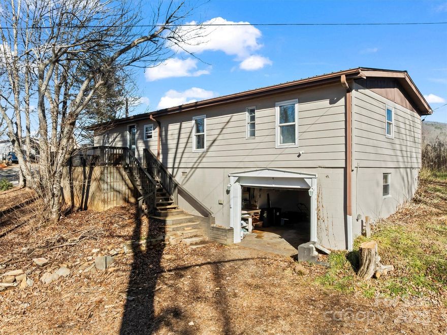 Discover the perfect blend of modern style and serene mountain living! This 3-bedroom, 2-bathroom home with split bedroom floor plan ensure maximum privacy. The spacious master suite is a private oasis, boasting a walk-in closet with motion-sensor lighting and a luxurious en-suite bath with a dual vanity. Situated on a level, 0.38-acre lot, this property is unrestricted—perfect for those dreaming of a small garden or a few chickens. Relax on the large wrap-around deck and soak in year-round mountain and valley views. This home sits over a one-car basement garage, ideal for a workshop or vehicle storage. Additional parking is available under the detached carport. You’ll enjoy the tranquility of a privately maintained road while staying close to local amenities. Whether you’re looking for a full-time residence or a mountain getaway, this home is ready for its next chapter.