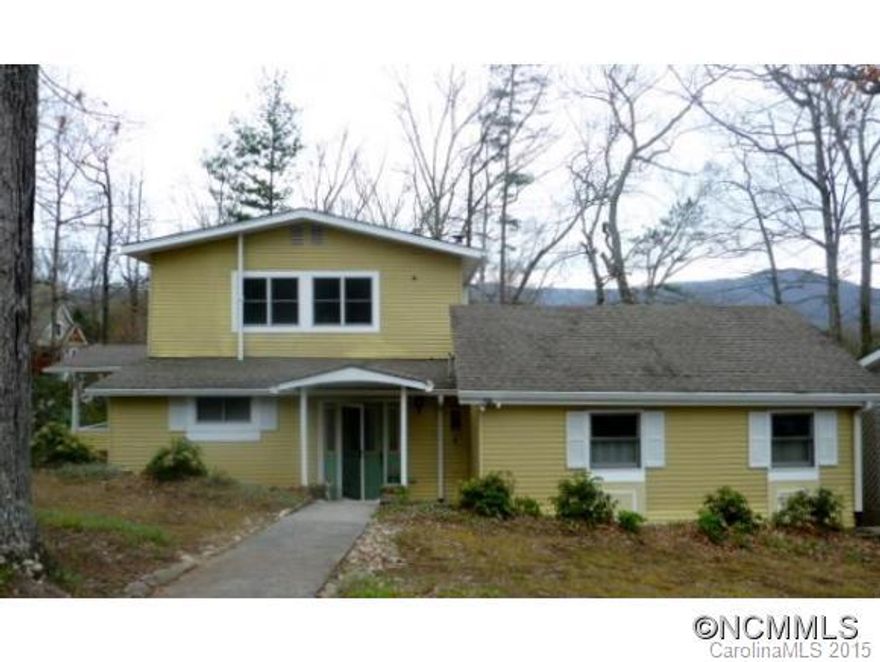 Walk to the lake, pool, & tennis courts from this classic 1940's era 5 BDR/3BA home. Golf & croquet course are within a mile. Enjoy the mountain view from the spacious covered back porch. There's an arched entry, fireplace, & many tall windows in the light filled living room. The large (.697) low maintenance yard & lot allow more time to enjoy the amenities of Black Mt living! Kitchen & baths need updating, but it would be money well spent.